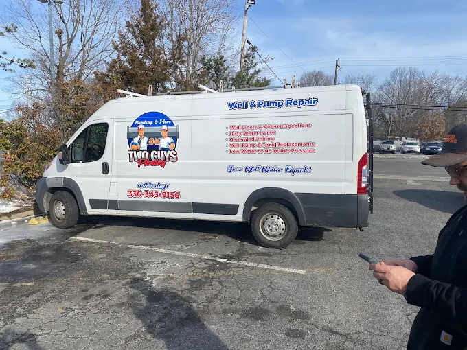Two Guys service van lettered with Well & Pump Repair services and phone number 336-343-9156